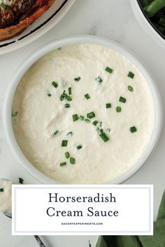 horseradish cream sauce in a white bowl with green onions on the side next to other dishes