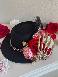 a black hat with flowers and a crown on it