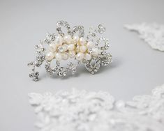 Spruce up your bridal ensemble with our petite clip. This stylish hair ornament showcases dainty ivory freshwater cultured pearl blooms, adding a hint of organic charm to your big day. The clip is about 2.75 inches long and 2 inches high on an alligator style pinch clip. Pearl Flowers, Crystal Wedding, Hair Ornaments, Stylish Hair