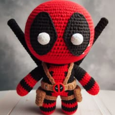 a crocheted deadpool doll sitting on top of a table