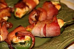 bacon wrapped jalapenos on a green plate