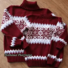 a red and white sweater with snowflakes is laying on the floor next to it