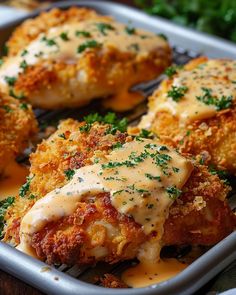 chicken parmesan with gravy on top in a baking pan ready to be eaten