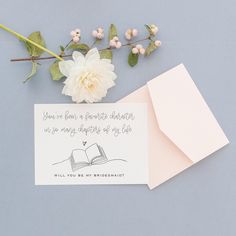 an open book and flowers on a table