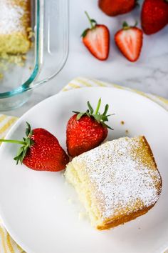 two pieces of cake on a plate with strawberries