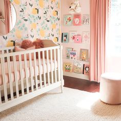 a baby's room decorated in pink and yellow