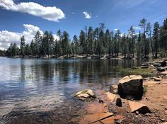 a lake surrounded by trees and rocks