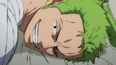 a man with green hair laying on the ground