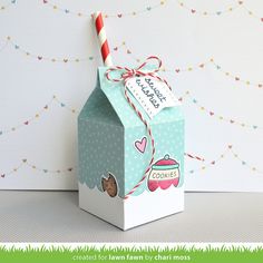 a small box with a candy cane sticking out of it