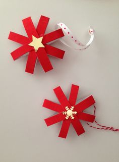 two red and white pinwheels with gold stars on them sitting next to each other