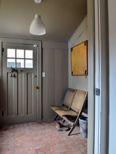 a wooden bench sitting in the middle of a hallway next to a door and window