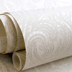 two rolls of white wall paper on top of each other