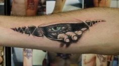 a man's arm with tattoos on it and an eye in the middle of his arm