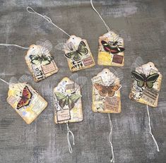 six tags with butterflies on them sitting on a table next to some twine string