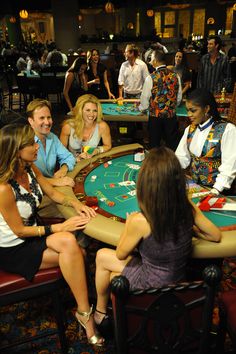 a group of people sitting around a casino table