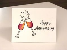 two glasses of wine are toasting with the words happy anniversary