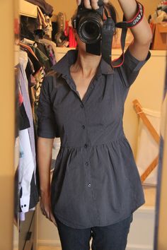 a woman taking a selfie in front of a mirror while holding a camera up to her face