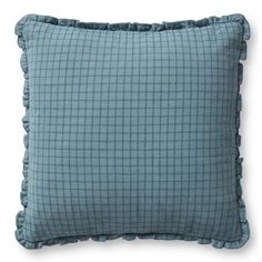 a blue pillow with ruffles on the front and back of it, against a white background