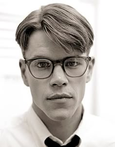 black and white photograph of a man wearing glasses