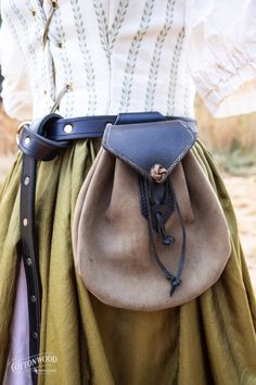 a close up of a person wearing a skirt with a bag on it's back