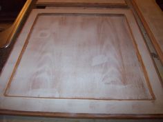 a close up of a wooden door frame on a counter top with the bottom panel missing