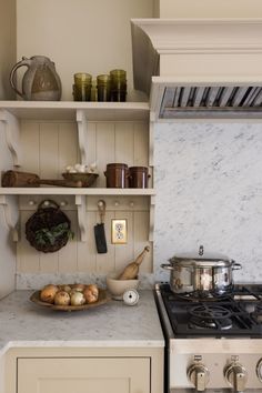 a stove top oven sitting inside of a kitchen