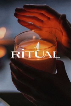 a person holding a lit candle in their hands with the words ritual on top of it