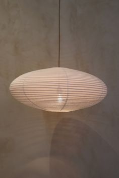 a white lamp hanging from a ceiling in a room