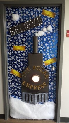 a door decorated to look like a replica of the polar express with gold ribbon around it