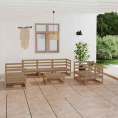 a room with wooden benches and potted plants