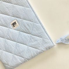 a blue and white checkered cloth with a button on it