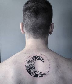 the back of a man's neck with a tattoo design on his upper part