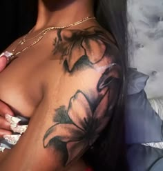 a woman with tattoos on her arm and chest