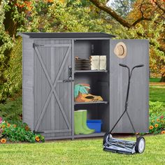 an outdoor storage shed with its door open and lawn mower in the foreground