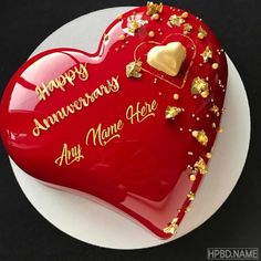 a red heart shaped cake with happy anniversary messages on it