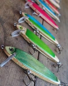 several different types of fishing lures lined up on a table