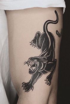 a black and white photo of a tattoo on the side of a woman's thigh