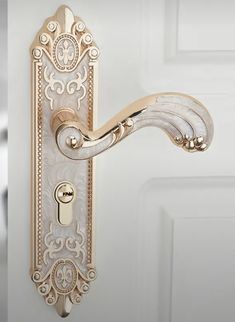 an ornate door handle on a white door