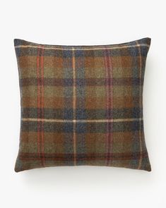 a brown plaid pillow on a white background