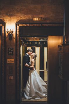 a bride and groom kissing in an elevator