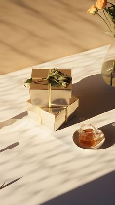 A table adorned with a flower-filled vase and neatly wrapped presents under the warm sunlight. Japanese Tea, Perfect Moment