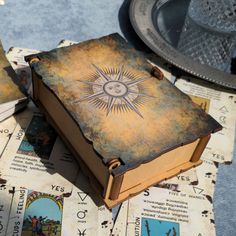 an open book sitting on top of a table next to other books and paper napkins