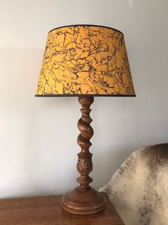 a lamp sitting on top of a wooden table next to a white cow's head