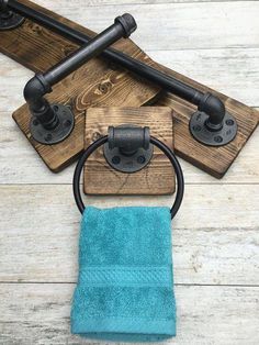 the towel holder is made out of wood and has two metal pipes on each side