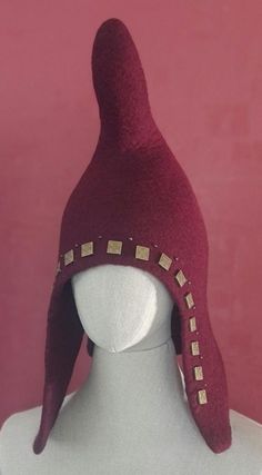 Felted Knights Helmet handmade felting technique. Very good qualityTyrolean wool, that is practical and durable. The wool felt is warming and wears extremely pleasantly, and the use of natural material is characteristic of the era of the Middle Ages. The cap's beautiful burgundy color is accentuated by zinc alloy metal decorations. It is a typical scythian hat Great for parties, re-enactments, medieval fairs  there is a great costume hat or just to keep your head and face warm. Please, always remember that colors  of images may look a bit different because  of your monitor's settings.  Ready to ship! Size about:  60cm/23.62"in Weight: lightweight, easy to wear Smell: wool, soap Touch:  wooly Delicate hand washing in the soap water (max. 40*C) recommended Visit my shop for more: https://www Mongolian Hat, Helmet Medieval, Medieval Hats, Medieval Fair, Peer Gynt, Metal Decorations, Viking Hat, Knights Helmet, Viking Helmet