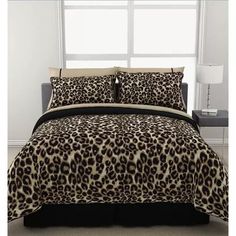 a leopard print comforter set on a bed