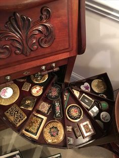 there are many different types of buttons in this display case on the floor next to each other