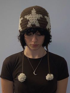 a woman wearing a brown and white crocheted hat