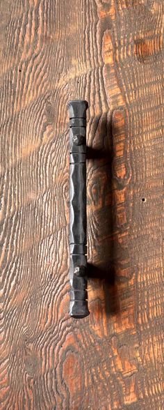 an old metal handle on a wooden door