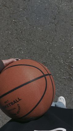 a person holding a basketball in their hand